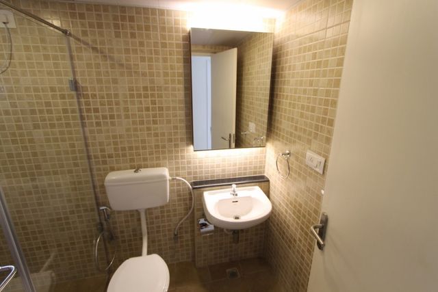 Bathroom with vanity unit and concealed lighting